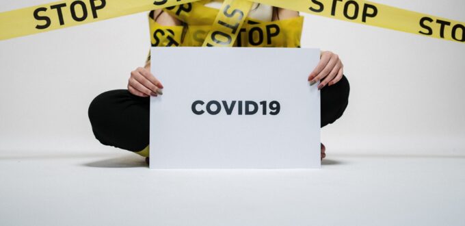 person holding covid sign